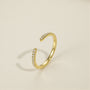 unusual womens wedding bands​, 5A CZ band ring, modern promise ring, cubic zirconia Rings, cz ring, wedding rings cz, eamti rings, cheap wedding rings under $50, copper ring, open band rings, open wedding band​. Gold open ring with small diamonds on a beige background